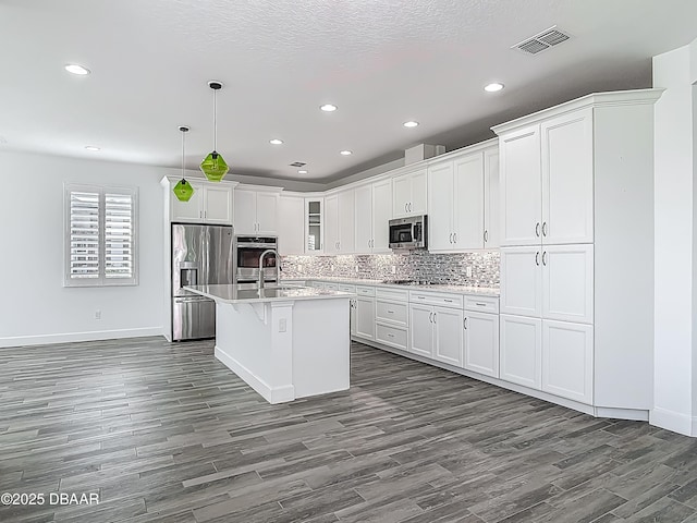 182 Island Breeze Ave, Daytona Beach, FL 32124 - kitchen featuring appliances with stainless steel finishes, dark wood-type flooring, recessed lighting, baseboards, and light countertops