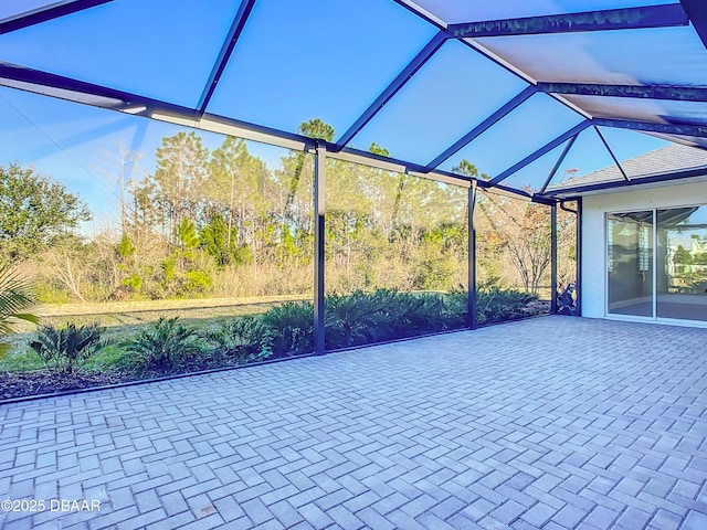 view of patio featuring glass enclosure