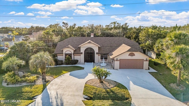 view of front of property featuring a front yard and a garage