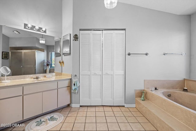 bathroom featuring tile patterned flooring, vanity, and shower with separate bathtub