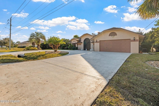 view of front of home featuring a garage and a front lawn