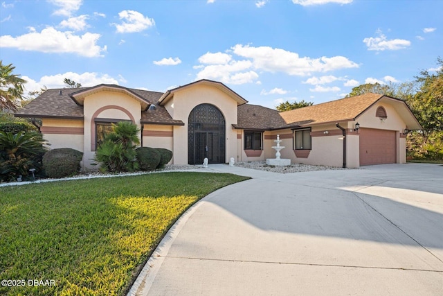 view of front of house featuring a garage and a front lawn