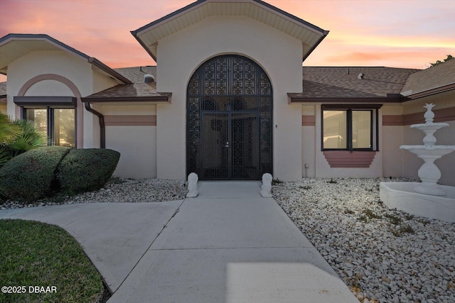 view of exterior entry at dusk