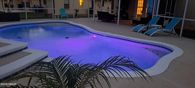 view of swimming pool featuring a lanai and a patio