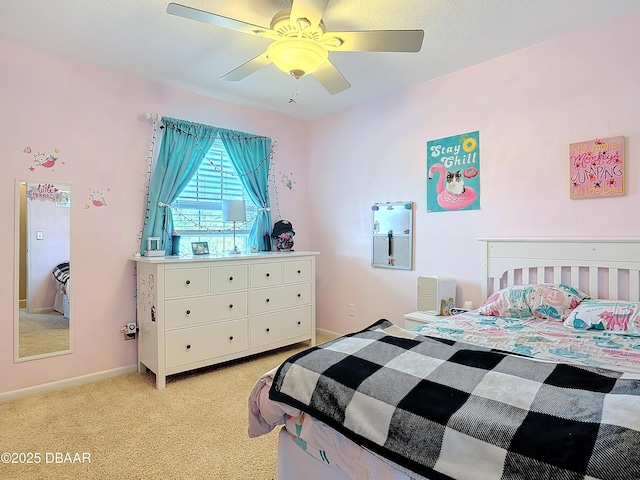 bedroom featuring a ceiling fan, baseboards, and light carpet