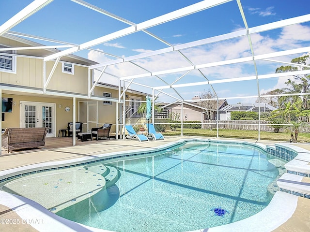 view of swimming pool with a fenced in pool, fence, a lanai, french doors, and a patio