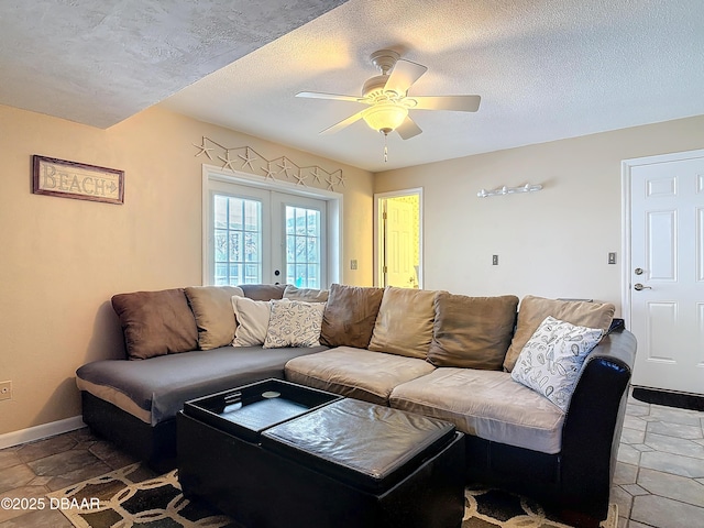 living room featuring french doors, baseboards, a textured ceiling, and ceiling fan