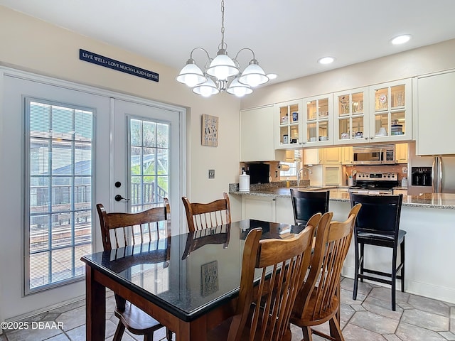 dining space with a notable chandelier, recessed lighting, and french doors