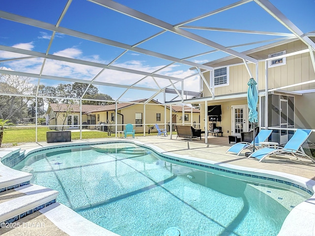 outdoor pool featuring a lanai and a patio area