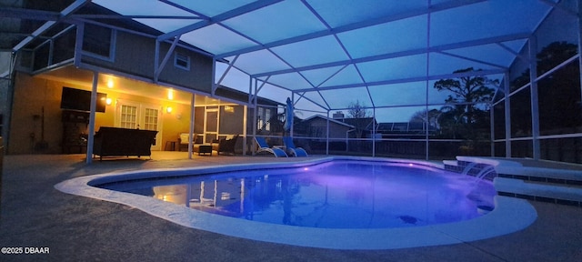 pool with a patio area and glass enclosure