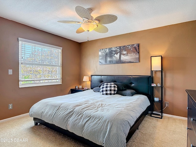 bedroom with carpet flooring, ceiling fan, a textured ceiling, and baseboards