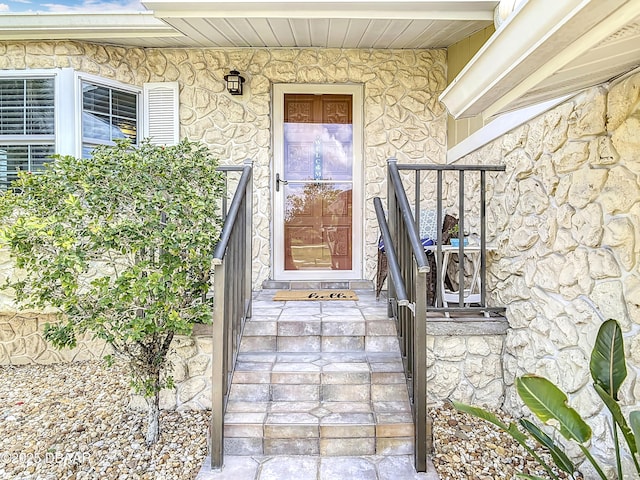 entrance to property with stucco siding and stone siding