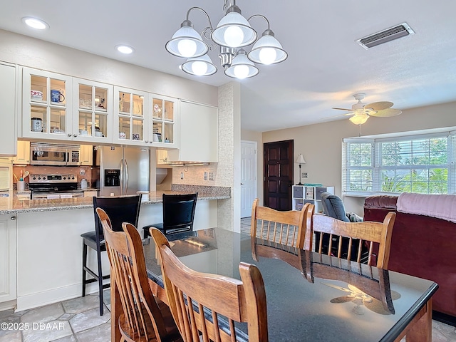 dining space with recessed lighting, visible vents, and ceiling fan with notable chandelier