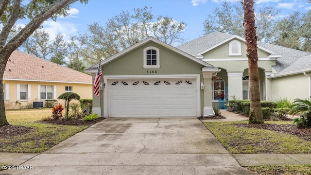 view of property featuring a garage, central AC, and a front yard