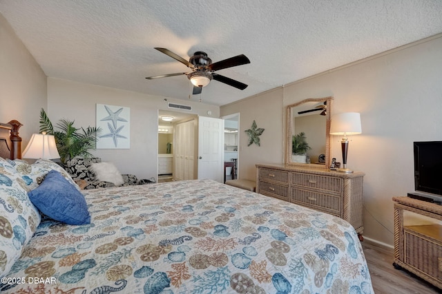 4139 S Atlantic Ave Unit A 302, New Smyrna Beach, FL 32169 - bedroom featuring wood finished floors, a textured ceiling, and a ceiling fan