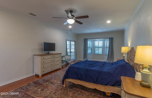 bedroom featuring ceiling fan, hardwood / wood-style floors, and ornamental molding