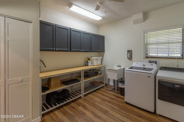 clothes washing area with washer and dryer, ceiling fan, cabinets, and dark wood-type flooring