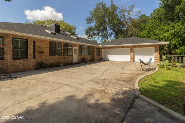 view of front of property with a front yard and a garage