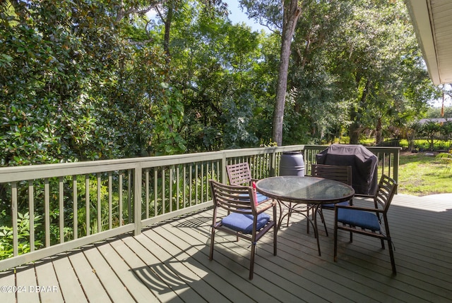 wooden terrace featuring a grill