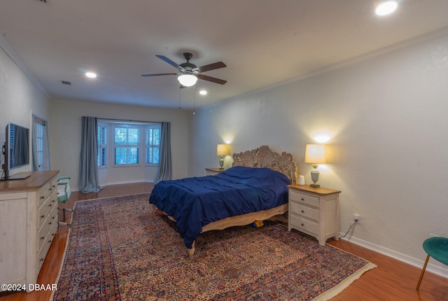 bedroom with wood-type flooring, ceiling fan, and ornamental molding