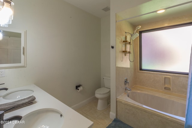 full bathroom featuring toilet, vanity, tile patterned floors, and tiled shower / bath