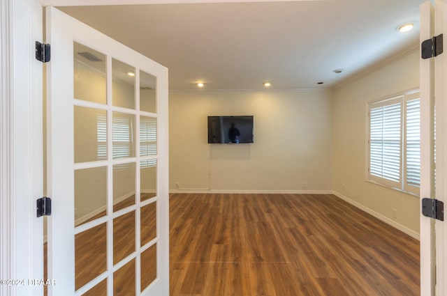 spare room with dark hardwood / wood-style flooring and ornamental molding