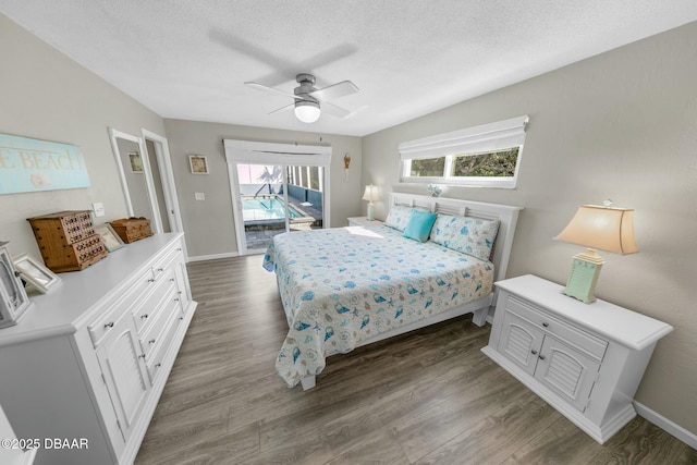 bedroom featuring access to exterior, multiple windows, hardwood / wood-style flooring, and ceiling fan