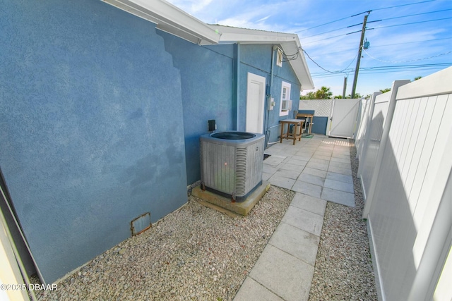 view of side of home featuring a patio area and central air condition unit