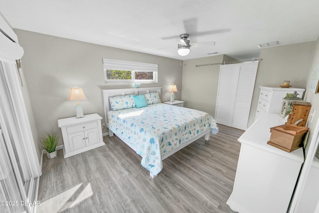 bedroom featuring light hardwood / wood-style flooring and ceiling fan