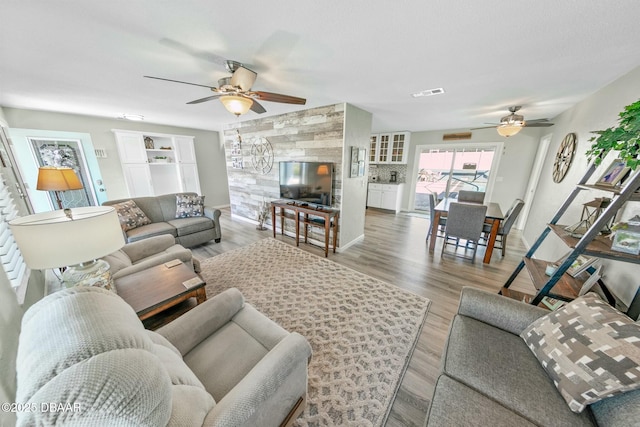 living room with ceiling fan and wood-type flooring