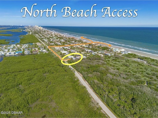 bird's eye view featuring a water view and a beach view