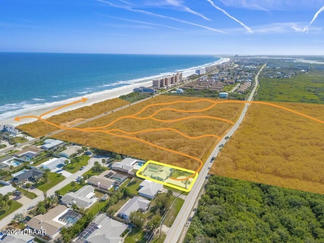 aerial view featuring a water view and a view of the beach