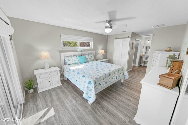 bedroom featuring ceiling fan and light hardwood / wood-style flooring