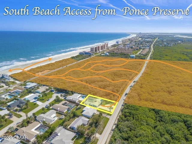 bird's eye view featuring a beach view and a water view