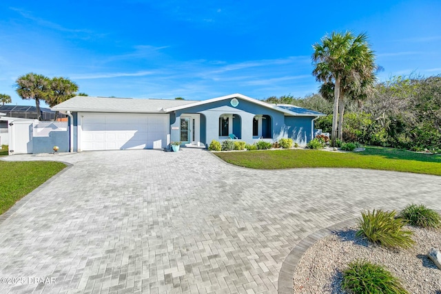 ranch-style home with a garage and a front yard