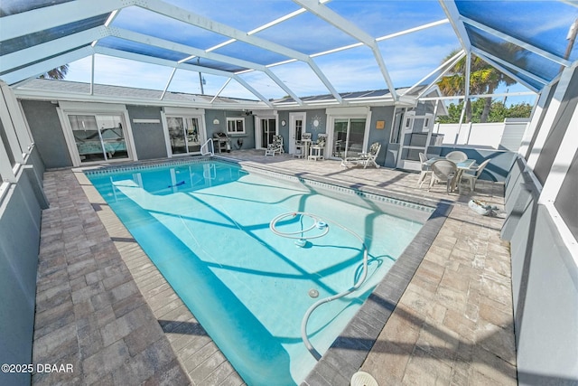 view of pool with a lanai and a patio