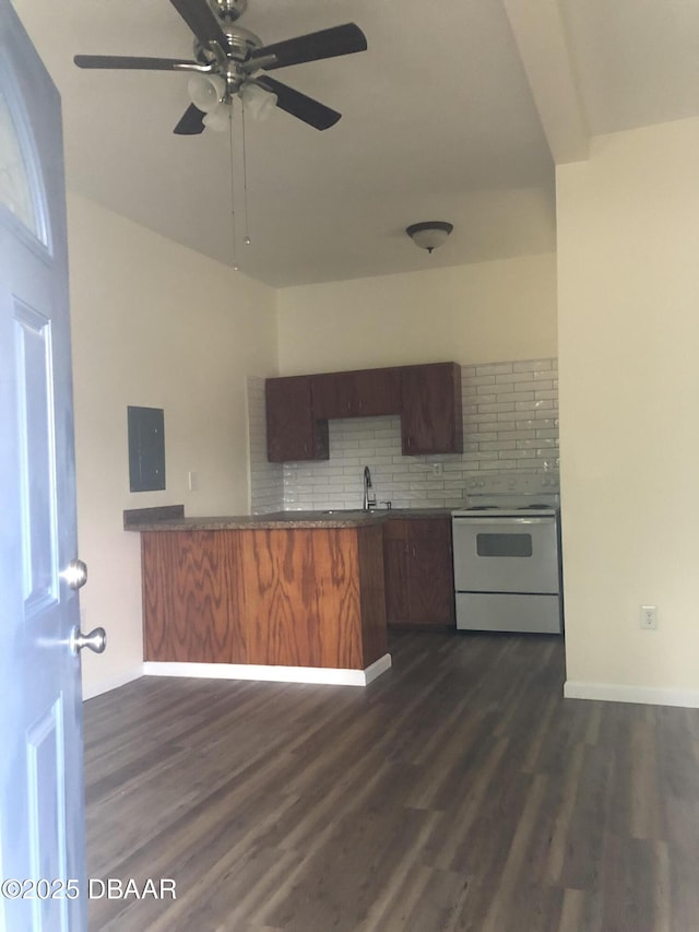 161 W 2nd Ave, Pierson, FL 32180 - kitchen featuring white range with electric stovetop, tasteful backsplash, ceiling fan, dark wood-type flooring, and dark countertops
