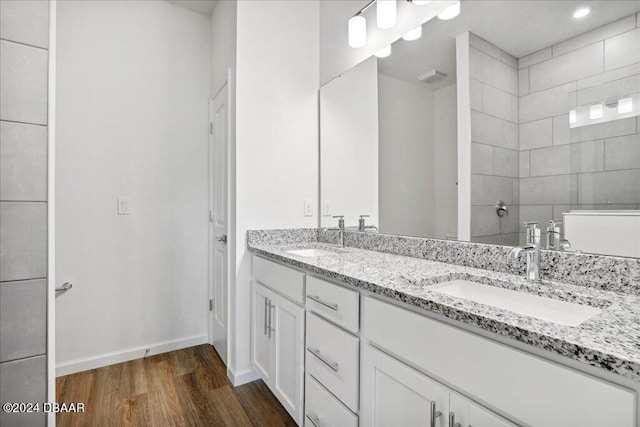 bathroom with vanity, hardwood / wood-style floors, and walk in shower