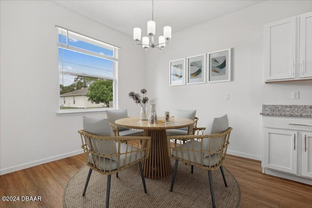 dining room featuring wood-type flooring and a chandelier