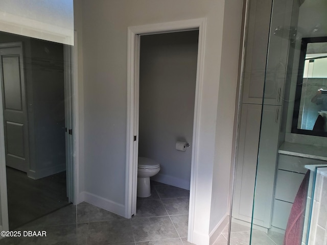 580 Barefoot Life Ln, Daytona Beach, FL 32124 - bathroom with toilet, a shower stall, baseboards, and tile patterned floors