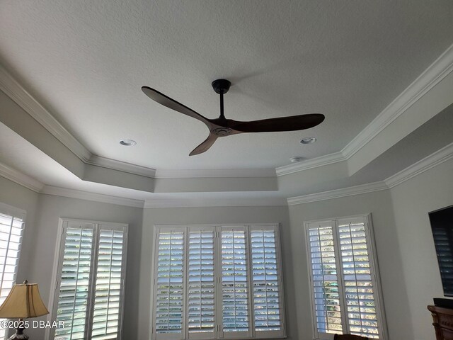 580 Barefoot Life Ln, Daytona Beach, FL 32124 - interior details with a ceiling fan, a raised ceiling, ornamental molding, and a textured ceiling
