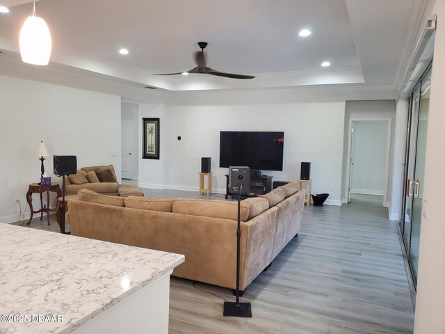 580 Barefoot Life Ln, Daytona Beach, FL 32124 - living room with light wood finished floors, a tray ceiling, and crown molding