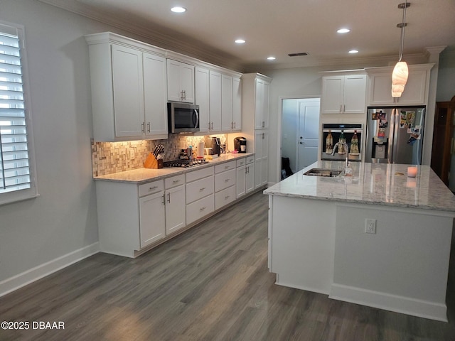 580 Barefoot Life Ln, Daytona Beach, FL 32124 - kitchen with hanging light fixtures, appliances with stainless steel finishes, a sink, and white cabinets