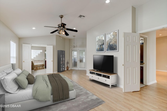 living room featuring lofted ceiling, ceiling fan, french doors, and light hardwood / wood-style flooring