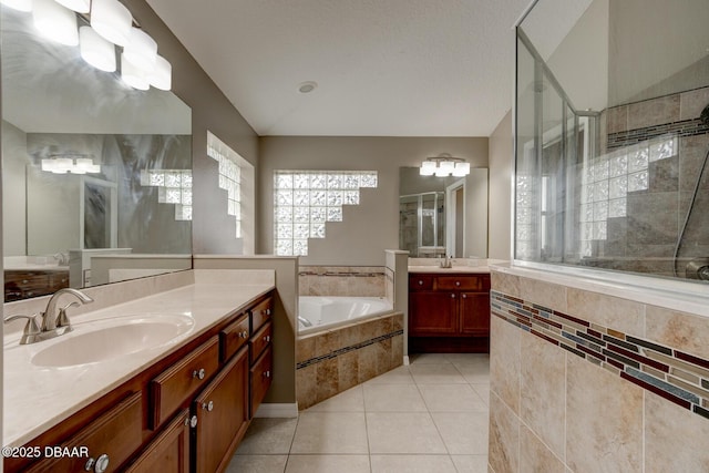 bathroom with vaulted ceiling, vanity, separate shower and tub, and tile patterned flooring