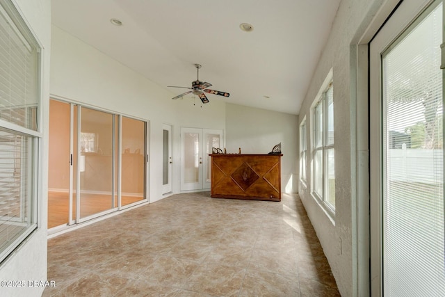 unfurnished sunroom with ceiling fan, french doors, and vaulted ceiling