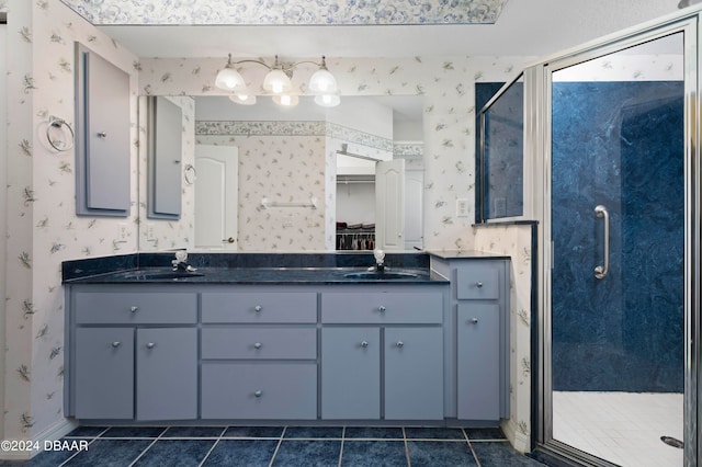 bathroom featuring walk in shower, vanity, and tile patterned floors