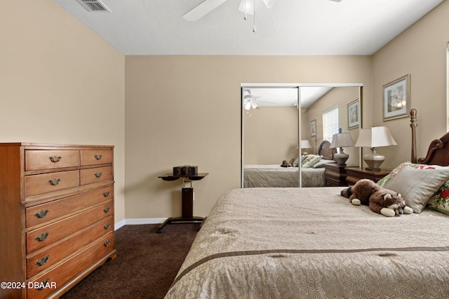 bedroom with a closet, dark colored carpet, and ceiling fan