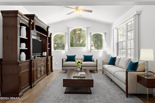 living room featuring ceiling fan, light hardwood / wood-style flooring, and vaulted ceiling