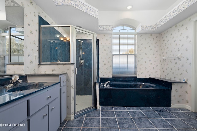 bathroom featuring vanity, plus walk in shower, and tile patterned flooring